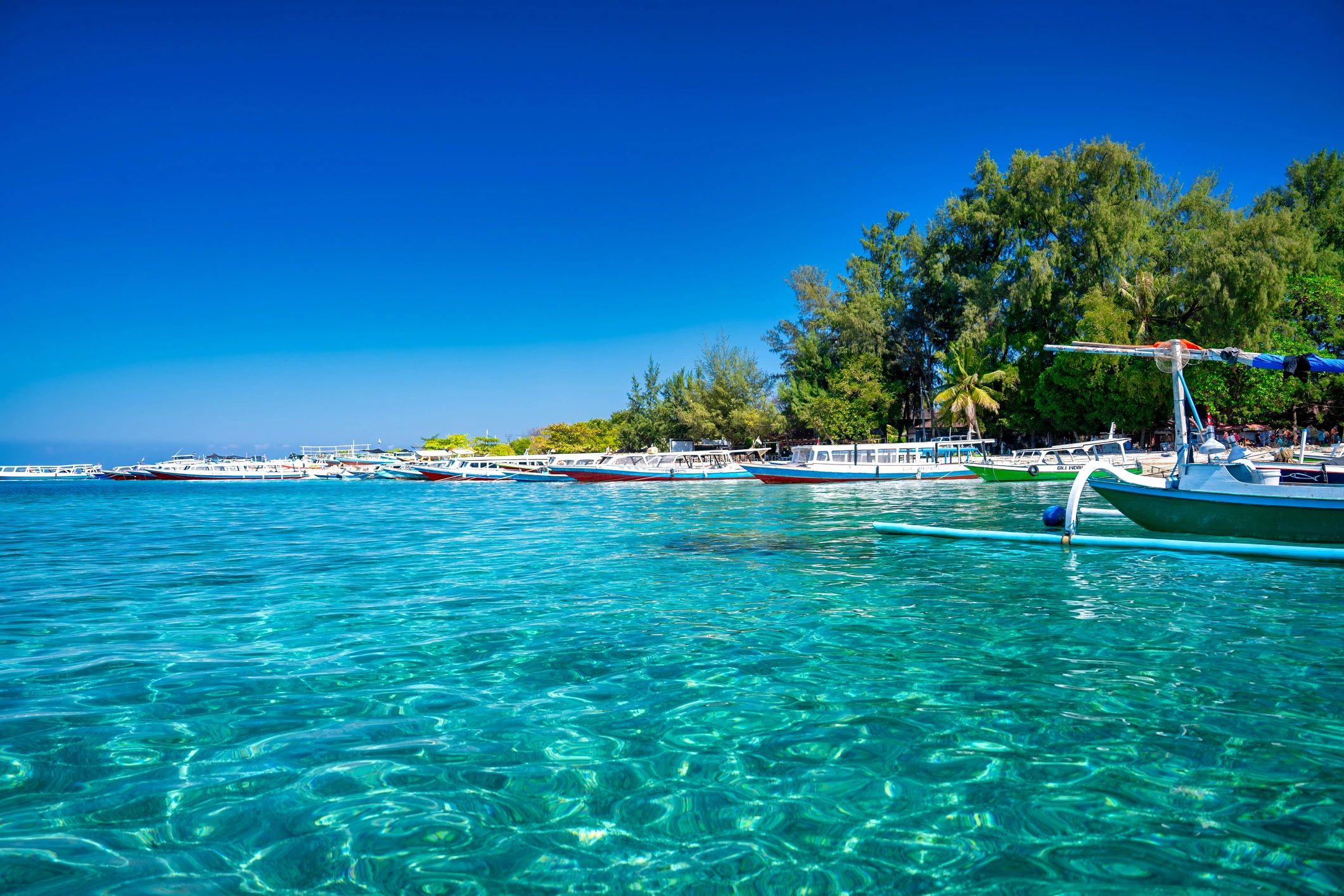 Aerial view of longtail boat in turquoise water